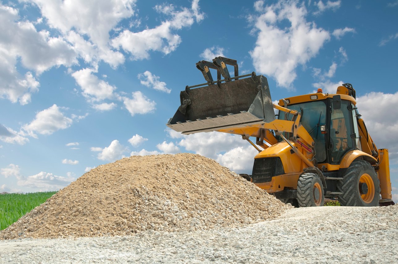 Excavator to a Pile of Rubble